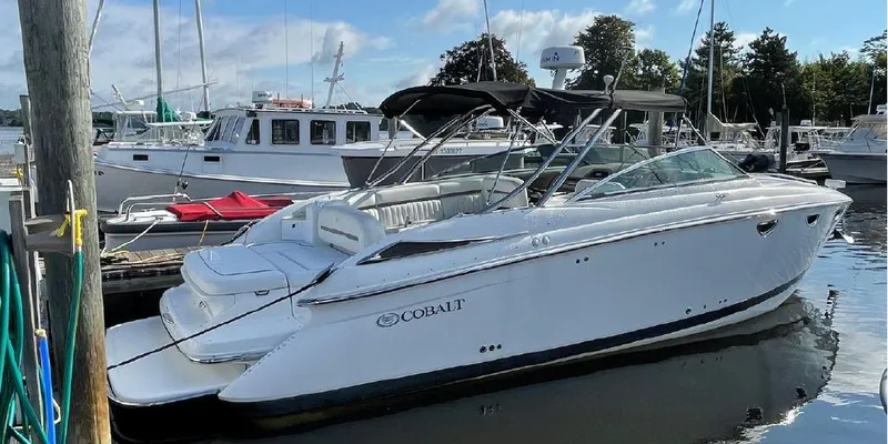 The Image of 2007 Cobalt 323 boat docked at a marina with other boats. - 0