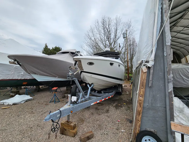 Slide: The Image of 2007 Cobalt 323 boat on a trailer in a storage yard. - 11