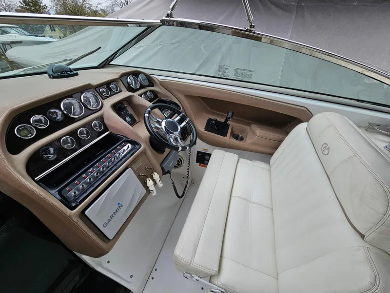 Slide: The Image of 2007 Cobalt 323 boat cockpit with steering wheel and control panel. - 3