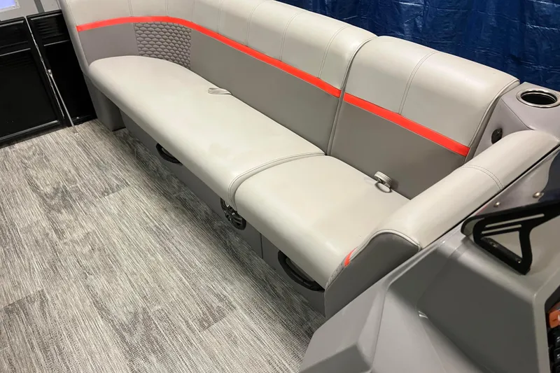 Slide: The Image of 2024 Angler Qwest 8522 LTZ Fish N Ski interior with gray seating and red accents. - 13