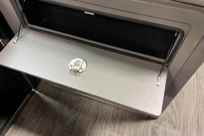 Slide: The Image of 2024 Angler Qwest 8522 LTZ FISH N SKI storage compartment with secure latch. - 15