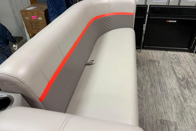 Slide: The Image of 2024 Angler Qwest 8522 LTZ FISH N SKI boat interior seating with red accent. - 17