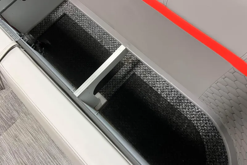 Slide: The Image of 2024 Angler Qwest 8522 LTZ FISH N SKI storage compartment with carpeted interior. - 20