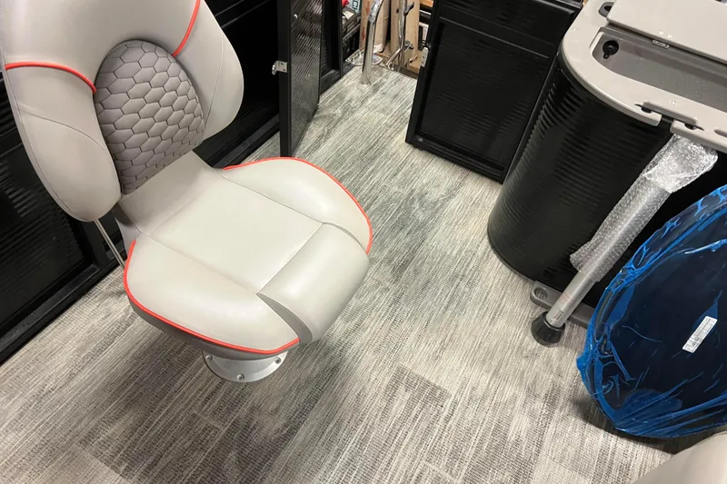 Slide: The Image of 2024 Angler Qwest 8522 LTZ FISH N SKI boat interior with cushioned seat and storage. - 22