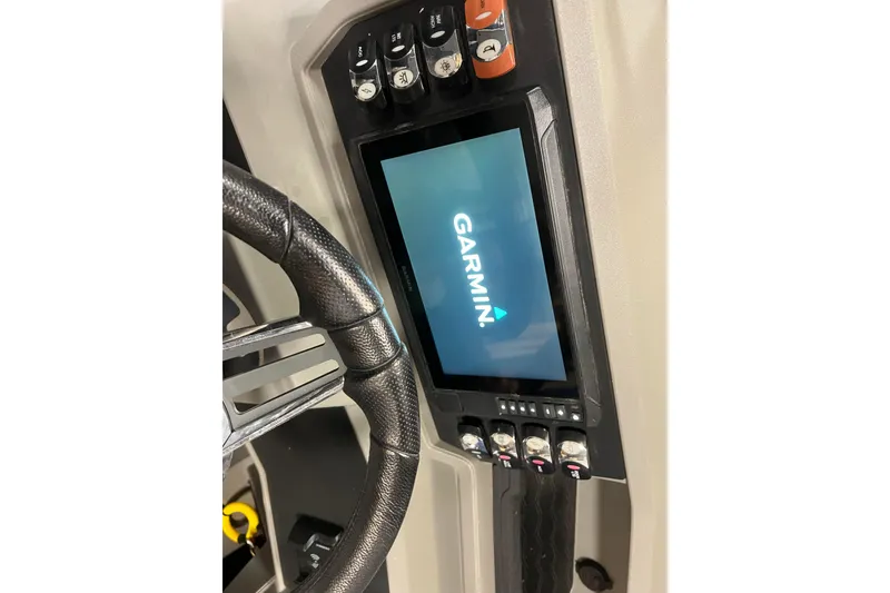 Slide: The Image of 2024 Angler Qwest 8522 LTZ Fish N Ski dashboard with Garmin display and controls. - 24