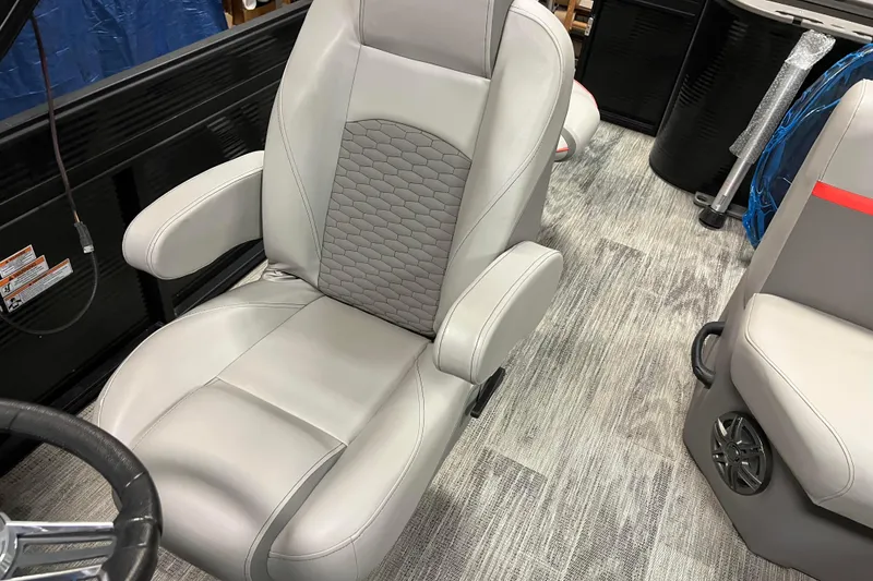Slide: The Image of 2024 Angler Qwest 8522 LTZ Fish N Ski boat seat with armrests and textured upholstery. - 26