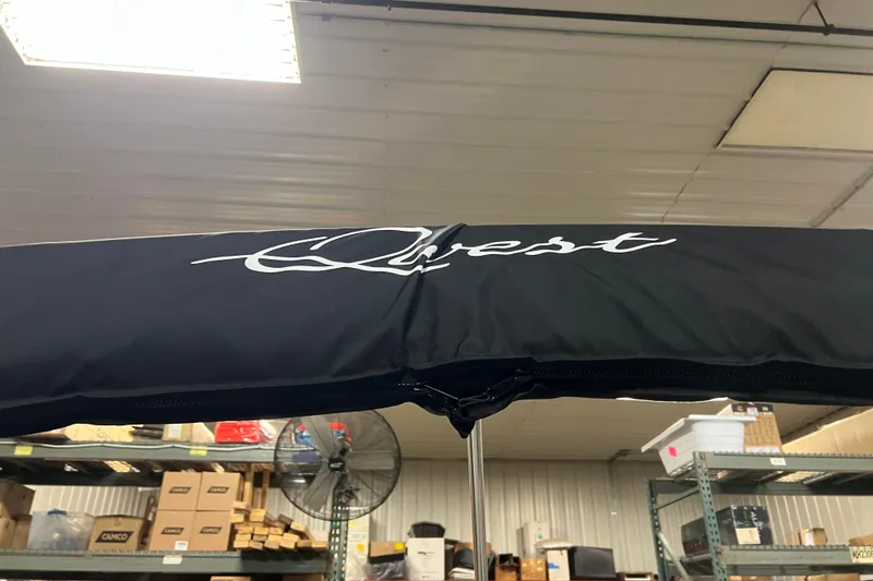 Slide: The Image of 2024 Angler Qwest 8522 LTZ Fish N Ski boat canopy in warehouse setting. - 28