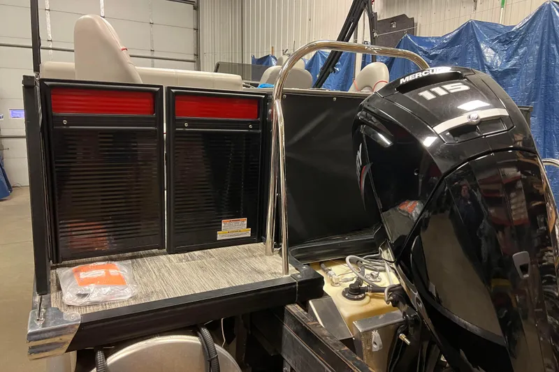 Slide: The Image of 2024 Angler Qwest 8522 LTZ Fish N Ski boat with Mercury 115 engine in a garage. - 4