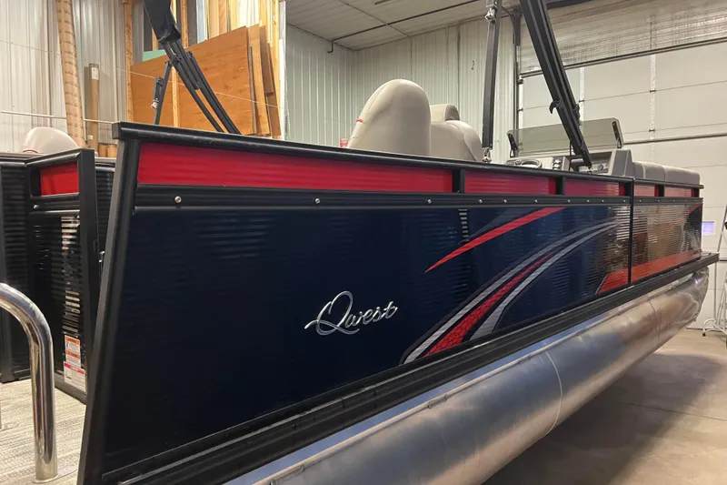 Slide: The Image of 2024 Angler Qwest 8522 LTZ Fish N Ski pontoon boat in a garage setting. - 5