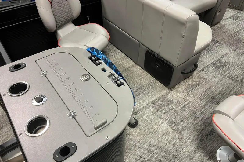 Slide: The Image of 2024 Angler Qwest 8522 LTZ Fish N Ski interior with seating and fishing station. - 8