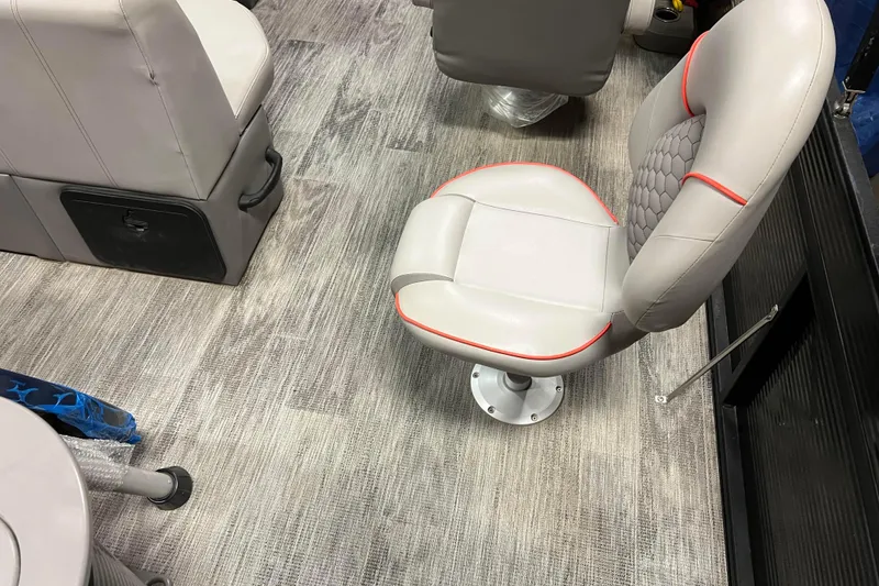 Slide: The Image of 2024 Angler Qwest 8522 LTZ Fish N Ski interior with gray seating and modern flooring. - 9