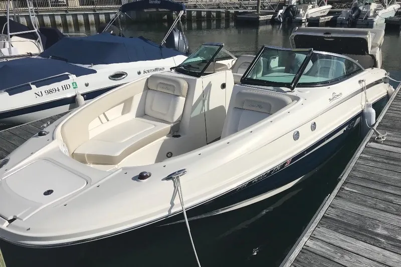 The Image of 2012 Sea Ray 240 Sundeck boat docked at marina, featuring spacious seating. - 0