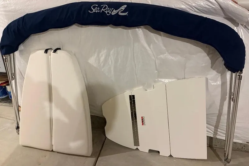 Slide: The Image of Items included with 2012 Sea Ray 240 Sundeck: anchor, life jackets, flotation device, fenders, manuals. - 11