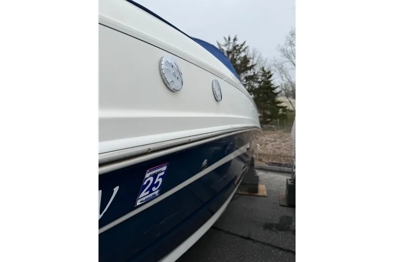 Slide: The Image of 2012 Sea Ray 240 Sundeck boat side view with registration sticker. - 17