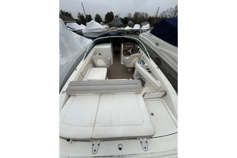 Slide: The Image of 2012 Sea Ray 240 Sundeck boat interior with white seating and dashboard view. - 21