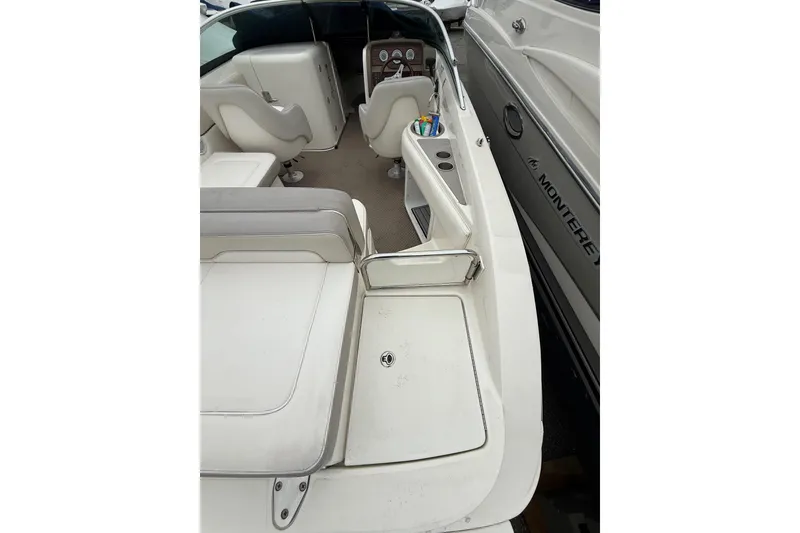 Slide: The Image of 2012 Sea Ray 240 Sundeck interior with seating and dashboard view. - 23