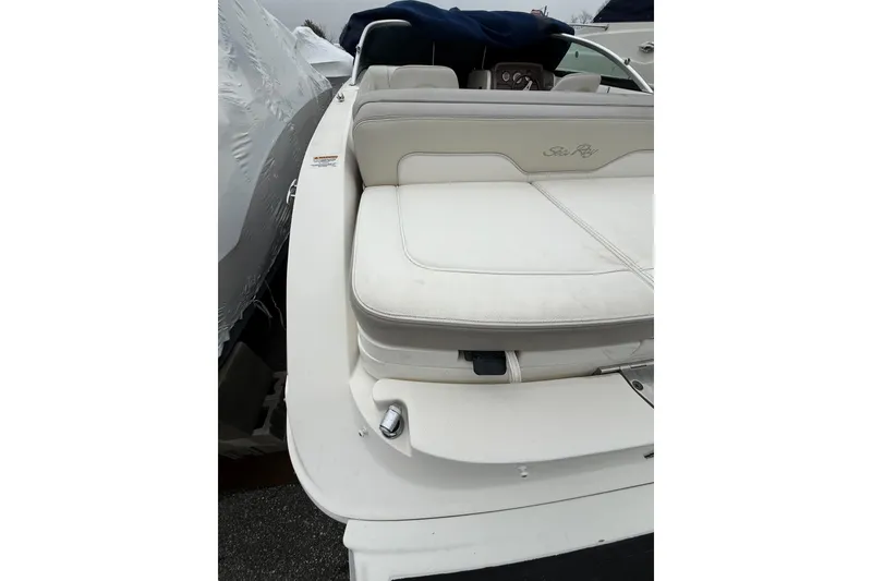 Slide: The Image of 2012 Sea Ray 240 Sundeck boat with white seating and sleek design. - 24