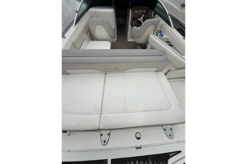 Slide: The Image of 2012 Sea Ray 240 Sundeck boat interior with white seating and dashboard view. - 25
