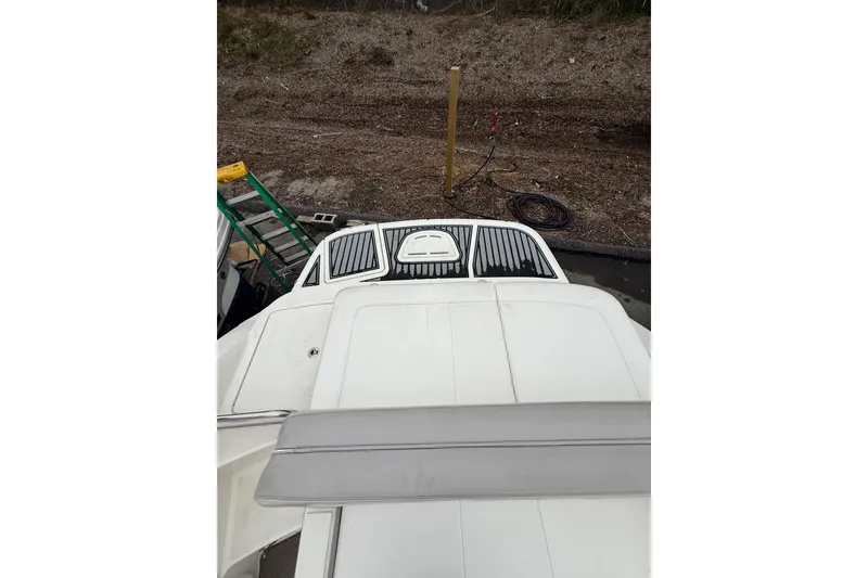 Slide: The Image of 2012 Sea Ray 240 Sundeck boat, rear view with swim platform and ladder. - 26