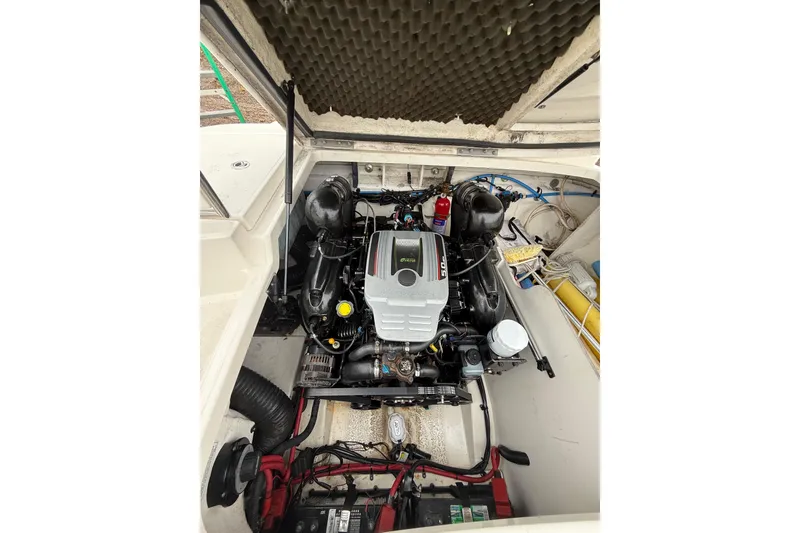 Slide: The Image of Engine compartment of a 2012 Sea Ray 240 Sundeck boat, showcasing detailed components. - 27