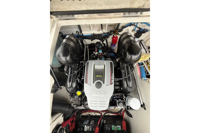 Slide: The Image of Engine compartment of a 2012 Sea Ray 240 Sundeck boat, featuring a MerCruiser 5.0 MPI engine. - 28