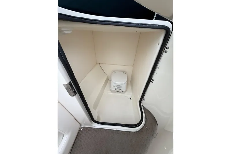 Slide: The Image of Interior view of 2012 Sea Ray 240 Sundeck boat's compact restroom. - 34