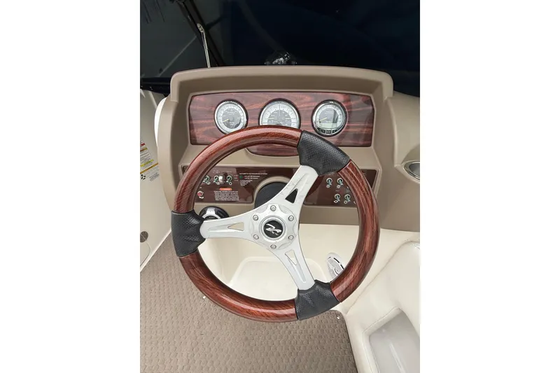 Slide: The Image of Steering wheel and dashboard of a 2012 Sea Ray 240 Sundeck boat. - 37