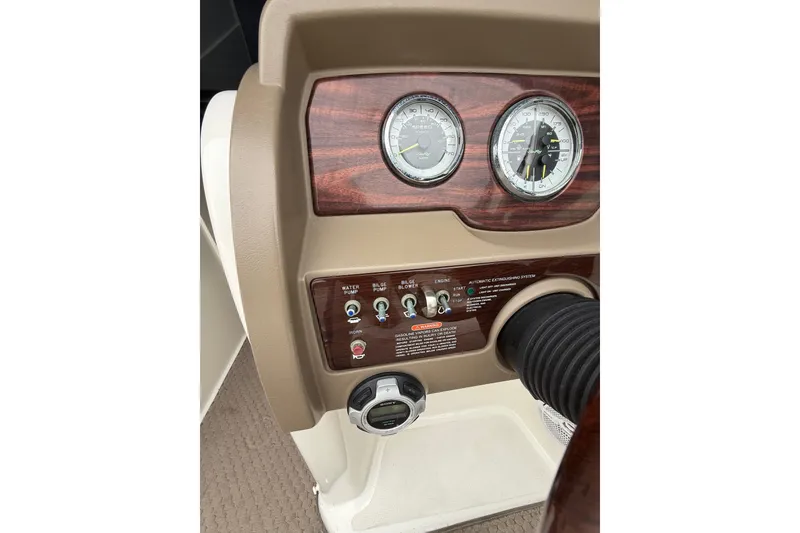 Slide: The Image of Dashboard of 2012 Sea Ray 240 Sundeck with gauges and control switches. - 38