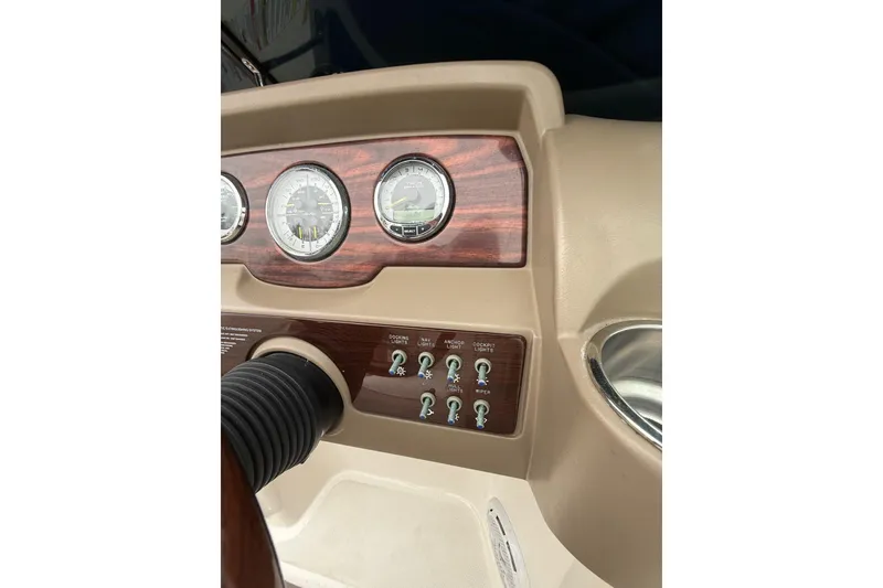 Slide: The Image of Dashboard of a 2012 Sea Ray 240 Sundeck boat with gauges and controls. - 39