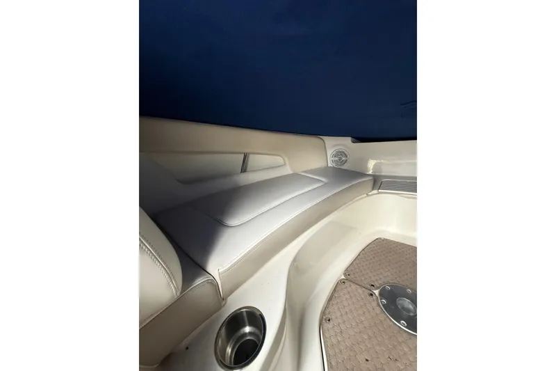 Slide: The Image of Interior of 2012 Sea Ray 240 Sundeck boat with cushioned seating and cup holder. - 41