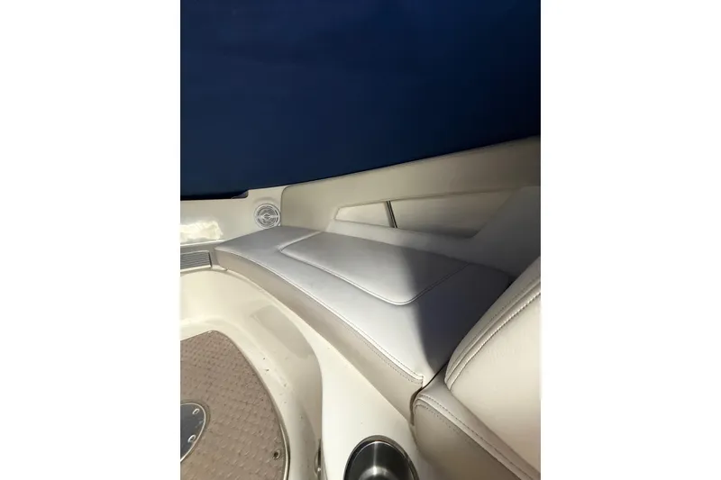 Slide: The Image of Interior seating of 2012 Sea Ray 240 Sundeck boat with beige upholstery. - 42