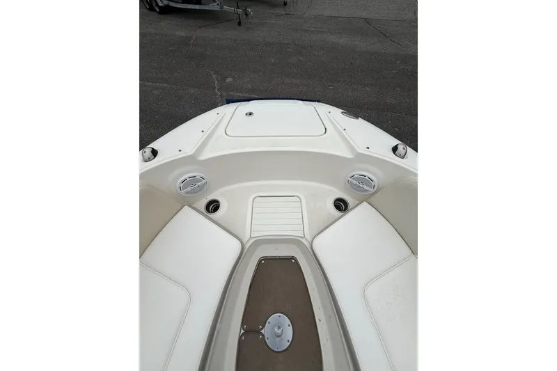 Slide: The Image of 2012 Sea Ray 240 Sundeck boat interior with white seating and deck details. - 47