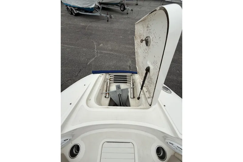 Slide: The Image of 2012 Sea Ray 240 Sundeck boat with open storage compartment on deck. - 48