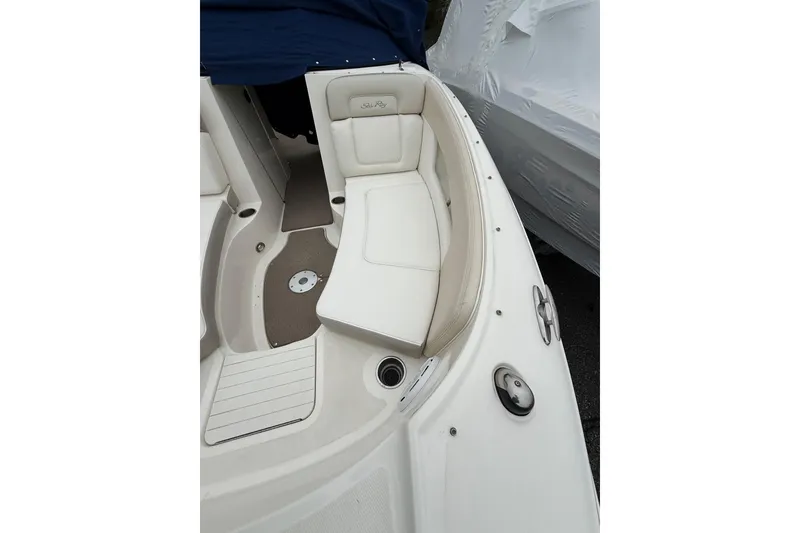 Slide: The Image of 2012 Sea Ray 240 Sundeck boat interior with white seating and deck details. - 49
