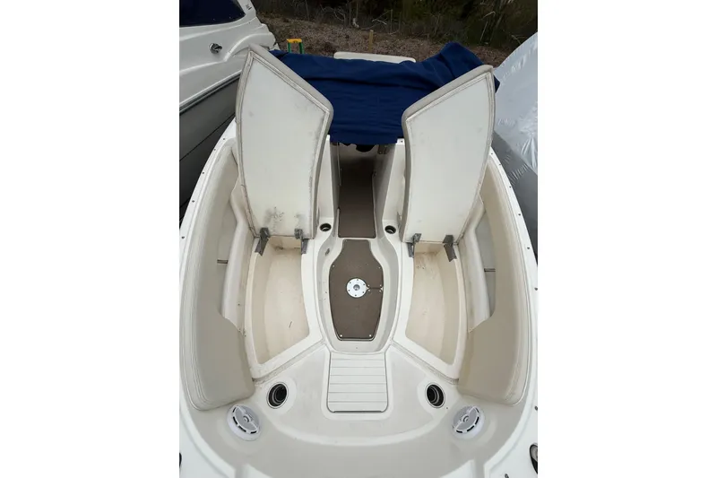 Slide: The Image of 2012 Sea Ray 240 Sundeck boat interior with open storage compartments. - 51