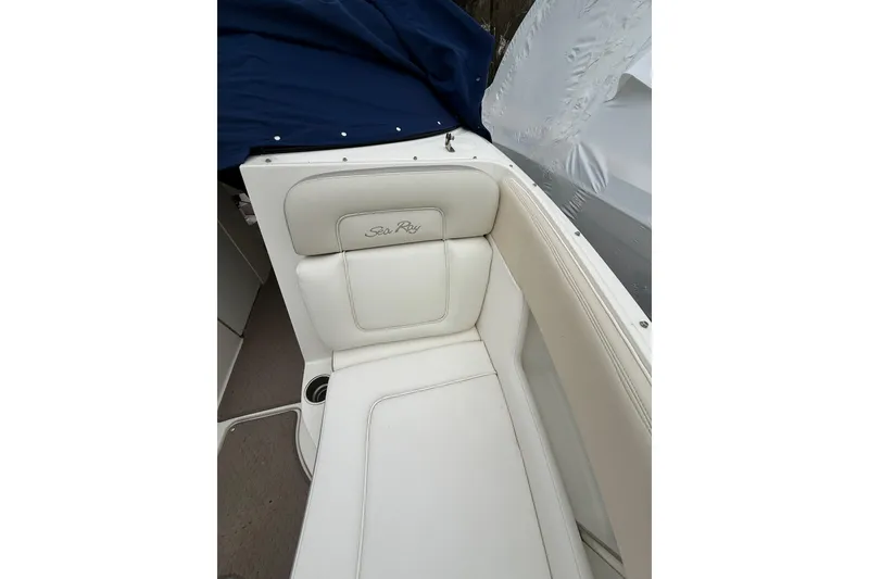 Slide: The Image of 2012 Sea Ray 240 Sundeck boat interior with white leather seating and cup holder. - 54