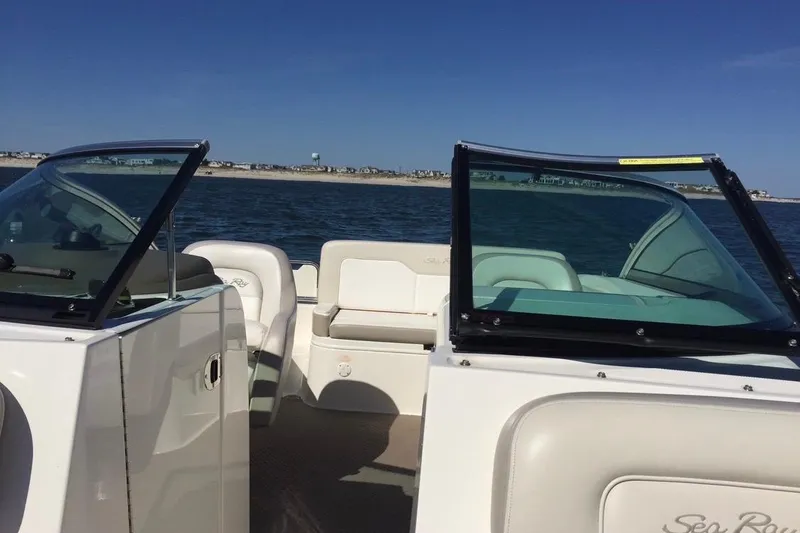 Slide: The Image of 2012 Searay 240 boat with blue cover docked at marina. - 6
