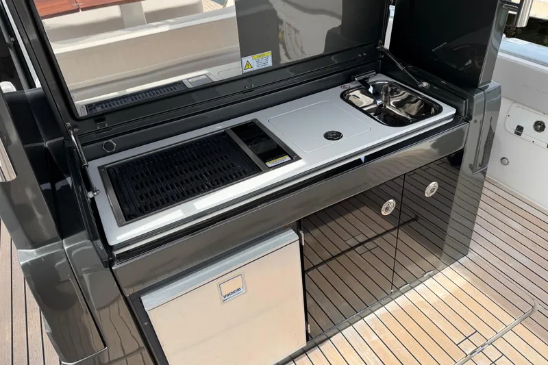 Slide: The Image of Outdoor kitchen on 2023 Schaefer V33 yacht with grill, sink, and storage. - 10