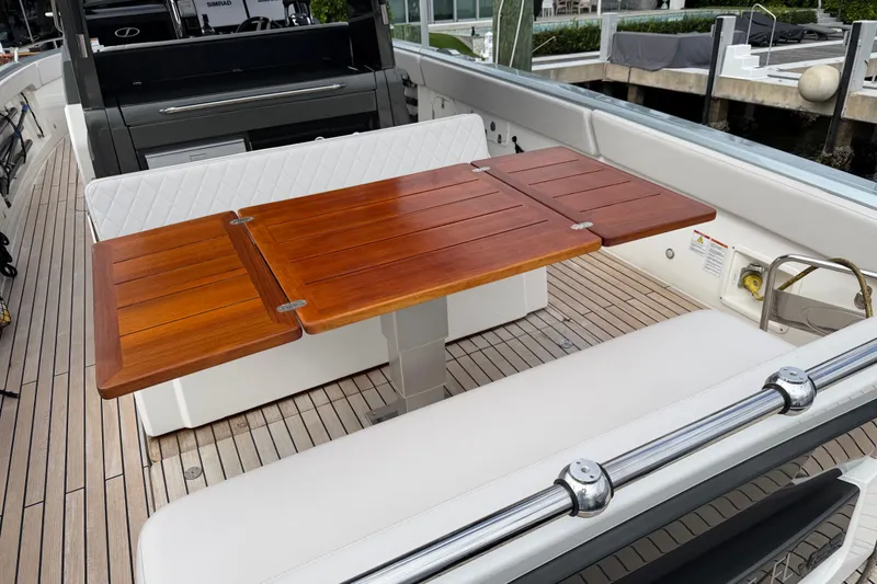 Slide: The Image of 2023 Schaefer V33 yacht with elegant wooden table and cushioned seating. - 11
