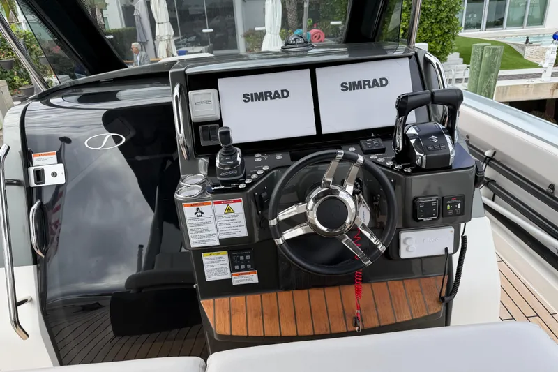 Slide: The Image of 2023 Schaefer V33 boat dashboard with dual Simrad displays and modern controls. - 7