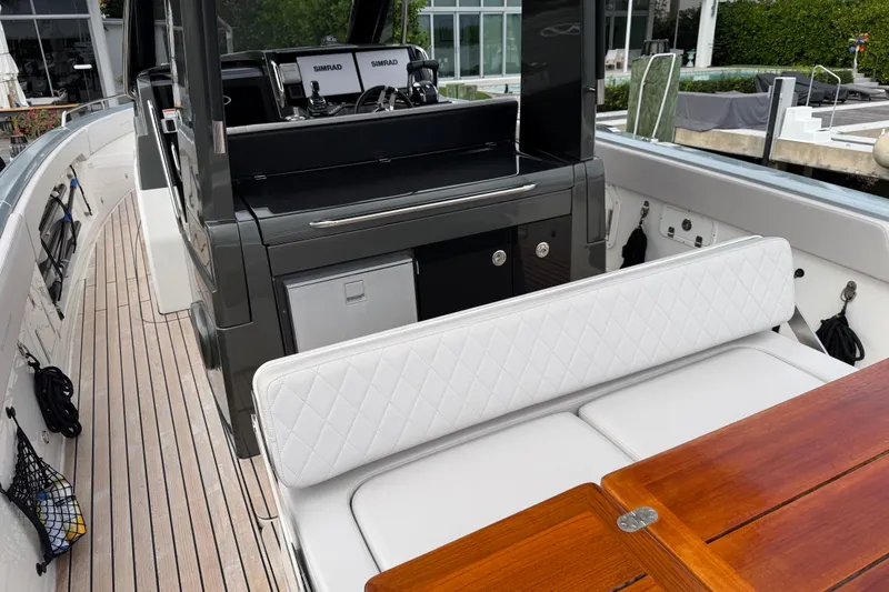 Slide: The Image of 2023 Schaefer V33 yacht interior with white seating and wooden table. - 9
