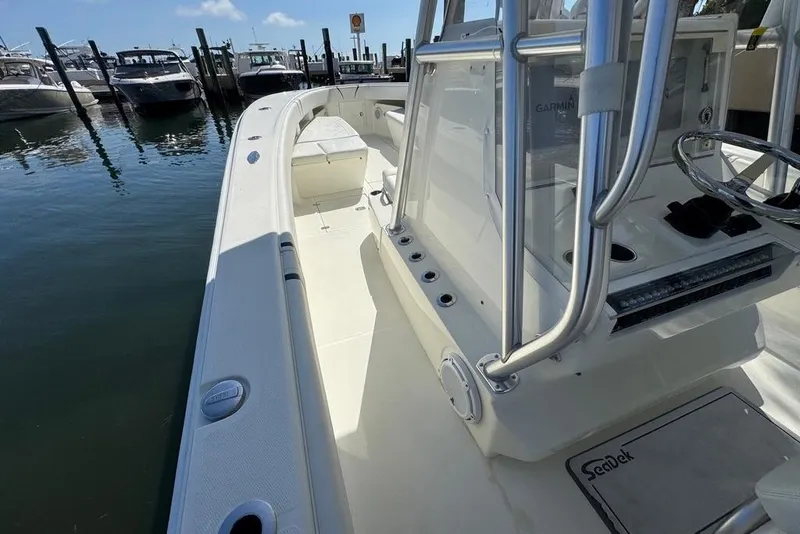 Slide: The Image of 2014 SeaVee 340B Open boat docked, featuring spacious deck and modern console. - 10