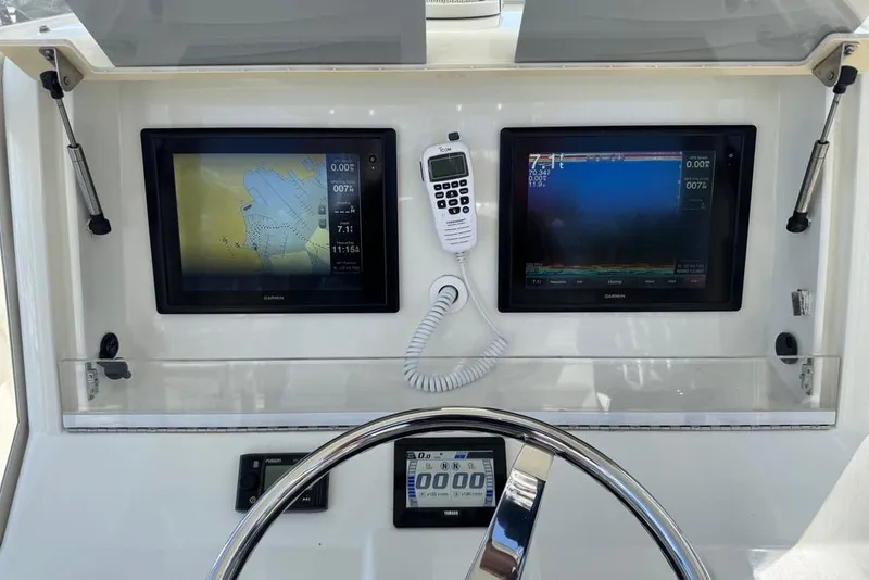 Slide: The Image of 2014 SeaVee 340B Open helm with dual Garmin displays and marine radio. - 13