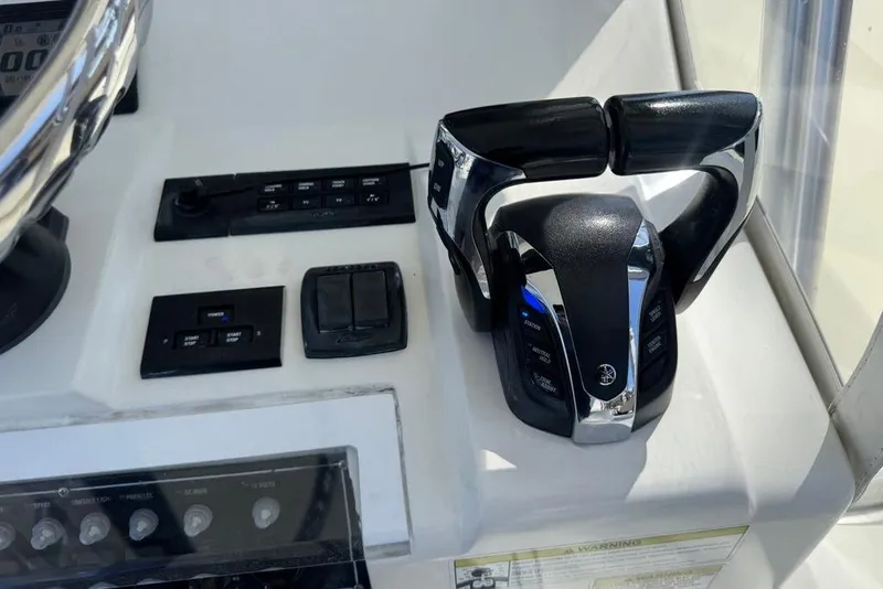 Slide: The Image of 2014 SeaVee 340B Open boat controls and dashboard with throttle and switches. - 14