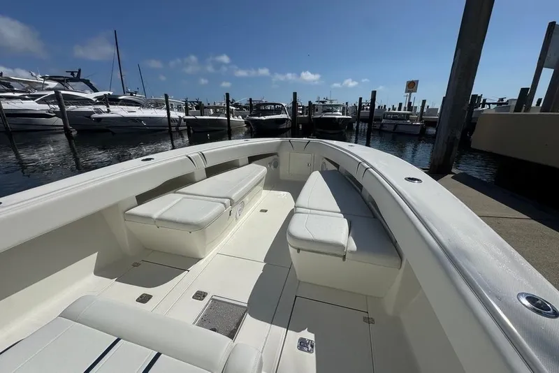 Slide: The Image of 2014 SeaVee 340B Open boat docked, featuring spacious seating and sleek design. - 17