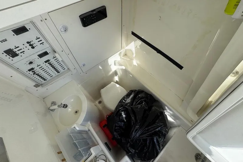 Slide: The Image of 2014 SeaVee 340B Open boat interior with control panel, sink, and storage area. - 19