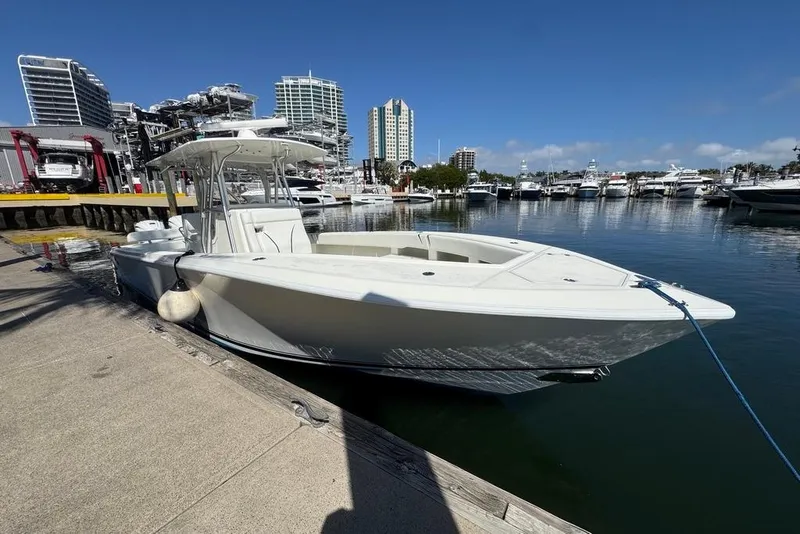 Slide: The Image of 2014 SeaVee 340B Open boat docked at a marina with city skyline. - 3