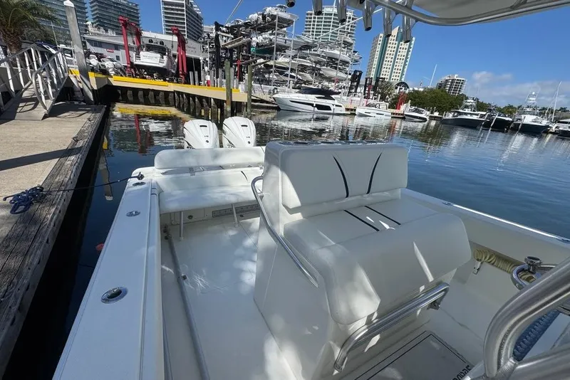 Slide: The Image of 2014 SeaVee 340B Open boat docked at marina with cityscape background. - 8