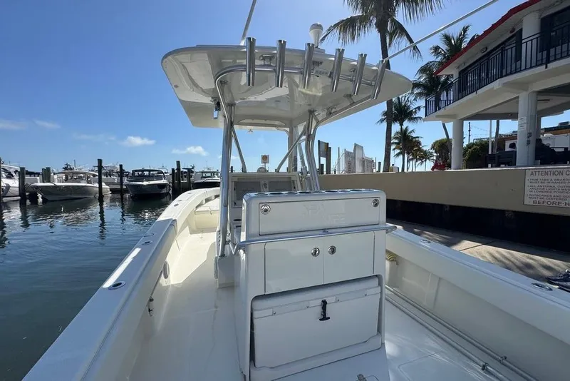 Slide: The Image of 2014 SeaVee 340B Open boat docked at marina under clear blue sky. - 9