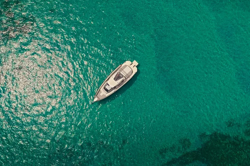 Slide: The Image of Aerial view of 2024 Maori 46ft yacht on clear turquoise water. - 11
